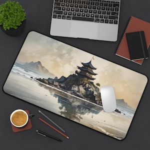 May include: A rectangular mousepad featuring a watercolor painting of a traditional pagoda on a rocky island, with a serene ocean and sky backdrop. The design includes a black border and a white mouse.