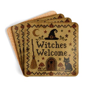 May include: A set of square cork coasters featuring a cross-stitch design on a tan background. The print displays the text Witches Welcome, a black cat, a broom, a witch hat, a crescent moon, mushrooms, and a small door, all framed by pumpkins.