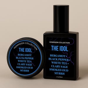 May include: Black perfume bottle and a round tin with the text "THE IDOL" and fragrance notes. The bottle is labeled "HONMOON COLLECTION" and contains 1.7oz/80ml. The tin also has the "HONMOON COLLECTION" label.