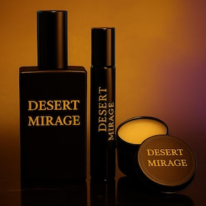 May include: Black fragrance bottles and a small jar with the text "DESERT MIRAGE" in gold lettering. The set includes a rectangular bottle, a roll-on bottle, and a jar with a lid. The background has a gradient of orange and purple.