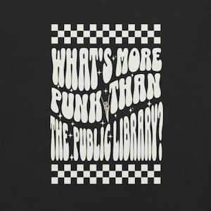 May include: White text on a black background with a checkered border. The text reads "What's more punk than the public library?" with a rock and roll hand gesture symbol in the middle of the text.