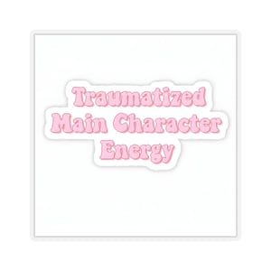 May include: Pink sticker with the text "Traumatized Main Character Energy" in a retro font.
