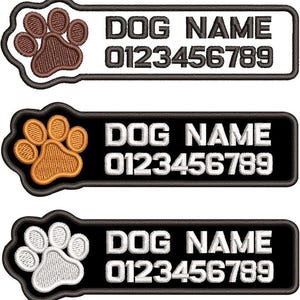 May include: Three embroidered dog tags with paw prints. Each tag has the words "DOG NAME" and a phone number. The tags are in black and white, with brown, orange, and white paw prints.