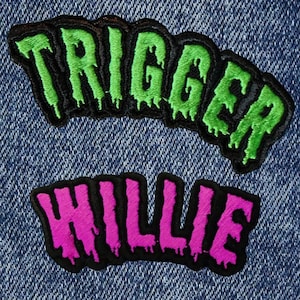 May include: Two embroidered patches, one green and one pink, with the words "TRIGGER" and "WILLIE" in a dripping font style.