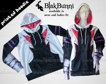 May include: Black and white zip-up hoodie with a red and white graphic design. The hoodie has a hood with a white lining. The text "Blak Bunni" is printed on the hoodie. The text "Available in Mens and Ladies Fit" is printed below the logo.
