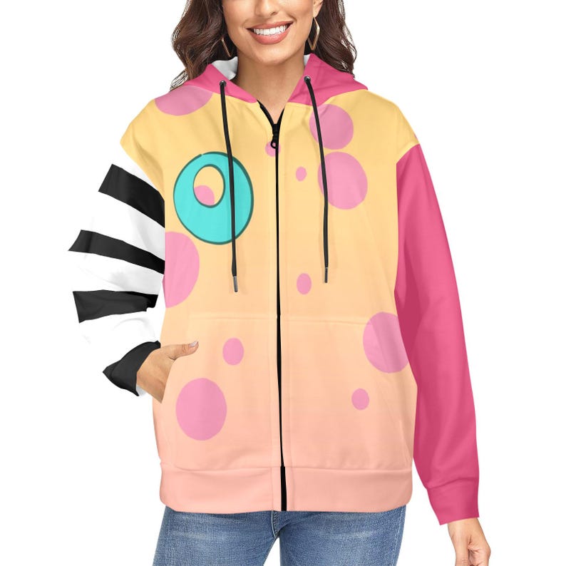 May include: A zip-up hoodie with a unique design. The hoodie features a color scheme of yellow, pink, and white. The left sleeve has black and white stripes, while the right sleeve is solid pink. The front has a large cartoon eye and pink polka dots.