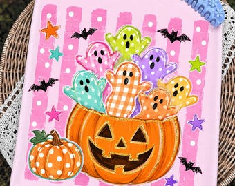 May include: A rectangular canvas print featuring a large orange jack-o'-lantern filled with colorful, patterned ghosts against a pink background with white polka dots. The design includes small black bats and multi-colored stars.