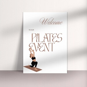 May include: A white poster with the words "Welcome to our Pilates Event" in brown script and serif fonts. An illustration of a person in black workout clothes doing a pilates pose is at the bottom.