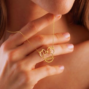Sparkle with the magic of Disney! Our adorable dainty minnie necklace for kids is a dream come true for your little fan. This personalized cartoon necklace combines the timeless charm of Mickey or Minnie Mouse with your child's very own name, creating a one-of-a-kind keepsake they will treasure on their next Disneyland trip and beyond.