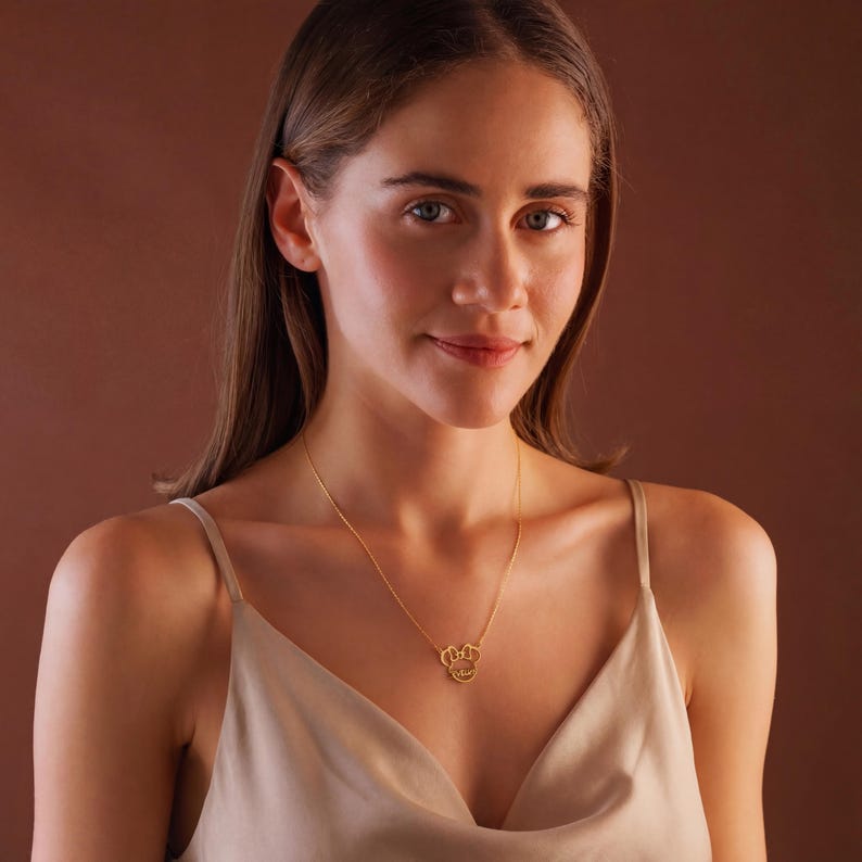 Sparkle with the magic of Disney! Our adorable dainty minnie necklace for kids is a dream come true for your little fan. This personalized cartoon necklace combines the timeless charm of Mickey or Minnie Mouse with your child's very own name, creating a one-of-a-kind keepsake they will treasure on their next Disneyland trip and beyond.