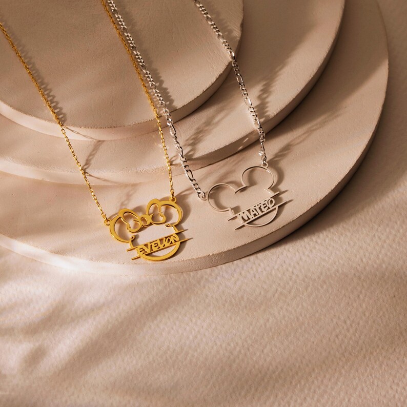 Sparkle with the magic of Disney! Our adorable dainty minnie necklace for kids is a dream come true for your little fan. This personalized cartoon necklace combines the timeless charm of Mickey or Minnie Mouse with your child's very own name, creating a one-of-a-kind keepsake they will treasure on their next Disneyland trip and beyond.