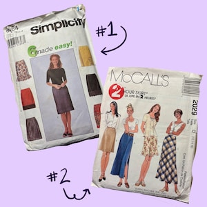 May include: Two vintage sewing patterns. The Simplicity pattern, labeled 8664, features a woman in a skirt. The McCall's pattern, labeled 2029, is for a two-hour skirt. Both patterns are on a purple background.
