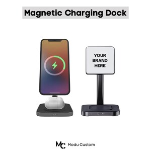 May include: A black magnetic charging dock with a phone, earbuds, and a sign that says "YOUR BRAND HERE". The phone displays a charging symbol. The text "Magnetic Charging Dock" is at the top.