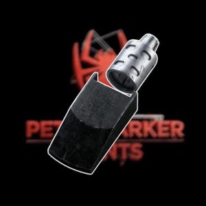 May include: A black and silver metal object with the text "PET MARKER PARTS" in red. The object appears to be a component of a marker or similar device, featuring a cylindrical part and a rectangular base.