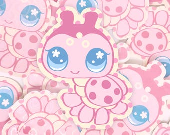 May include: A collection of die-cut stickers featuring a pink ladybug character with large blue eyes, white flower-shaped pupils, and dark pink spots. The text sonnyswagpack is printed in a small, dark font near the bottom centre of the image.