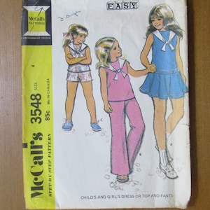 May include: Vintage McCall's 3548 sewing pattern for children's dress, top, and pants. The cover features illustrations of girls in outfits, including a blue dress, pink pants, and a shorts set. The pattern is marked "EASY".