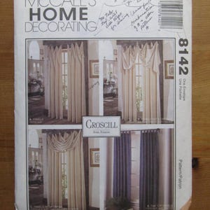 May include: A vintage McCall's Home Decorating pattern envelope. The front features images of various curtain styles, including panels and swags. The envelope has handwritten notes and the number 8142.