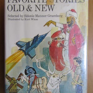 May include: Book cover with the title "More Favorite Stories Old & New" in bold, black text. The cover features colorful illustrations of a rocket, a deer, a knight on horseback, a man in a turban, and a boy. The book is a revised edition.