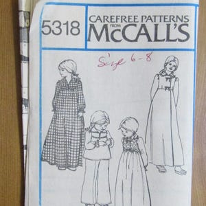 May include: A vintage McCall's sewing pattern, featuring illustrations of children's clothing designs. The pattern is labeled "Carefree Patterns" and includes the number 5318 and size 6-8. The designs include dresses and a coat.