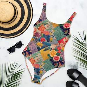 May include: A one-piece swimsuit featuring a vibrant patchwork design of various floral patterns, including yellow, pink, and red blossoms, set against deep blue, gold, and teal geometric backgrounds with a scoop neckline and thin shoulder straps.