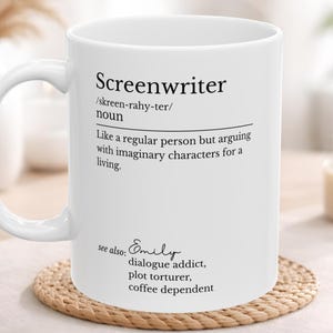 May include: White ceramic mug with the word "Screenwriter" and its definition printed on the side. The definition reads "Like a regular person but arguing with imaginary characters for a living." Additional text includes "see also: Emily, dialogue addict, plot torturer, coffee dependent."