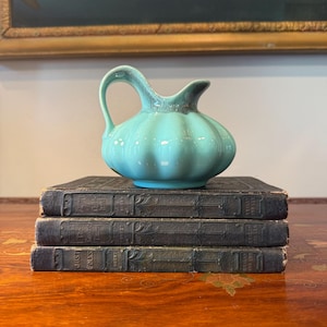 May include: A rustic wooden sign with the text "Welcome to our home" in white lettering. The sign features a distressed finish and a simple, inviting design, perfect for a front porch or entryway.