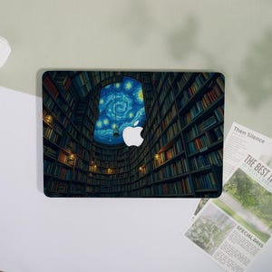 May include: Laptop skin featuring a library interior with a starry night sky visible through an arched window. The Apple logo is prominently displayed. The design incorporates warm and cool tones, creating a visually appealing aesthetic.