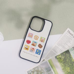 May include: A white phone case with a black border, featuring a collage of cartoon bear illustrations. The case has a cream-colored background and includes the text "A Red nose with come magic power."