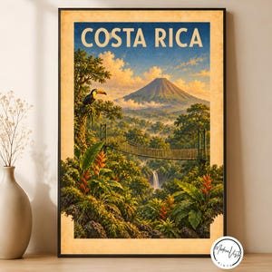 May include: A framed travel poster featuring the text COSTA RICA at the top. The illustration depicts a lush tropical landscape with a large volcano, a suspension bridge, a waterfall, vibrant red heliconia flowers, and a toucan perched in a tree.