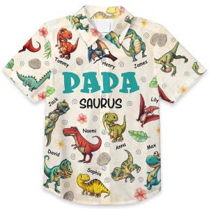 May include: Short-sleeved button-down shirt with a cream background and a colorful dinosaur print. The shirt features the text "PAPA SAURUS" and various dinosaur names. The design includes cartoon dinosaurs, flowers, and leaves.
