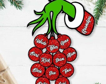 May include: A Christmas ornament featuring a green hand holding a red and white glove with the word "Grandpa". Below, there are 12 red ornaments with names like Wade, Tyler, and Gene. The ornament is designed for the holiday season.