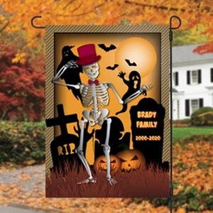 May include: Halloween garden flag featuring a skeleton wearing a top hat and bow tie, with a full moon and bats in the background. The flag includes the text "Brady Family 2000-2020" and jack-o'-lanterns.