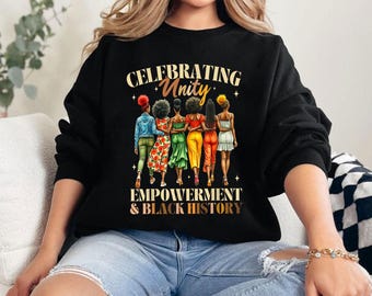 May include: Black sweatshirt with a graphic of five women walking together. The text "Celebrating Unity Empowerment & Black History" is printed on the sweatshirt.