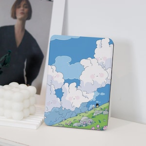 May include: A blue and white illustrated phone case with a design of fluffy clouds and two figures walking on a green hill with pink flowers.