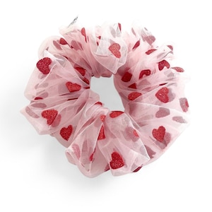 May include: A pink hair scrunchie with red glitter hearts.