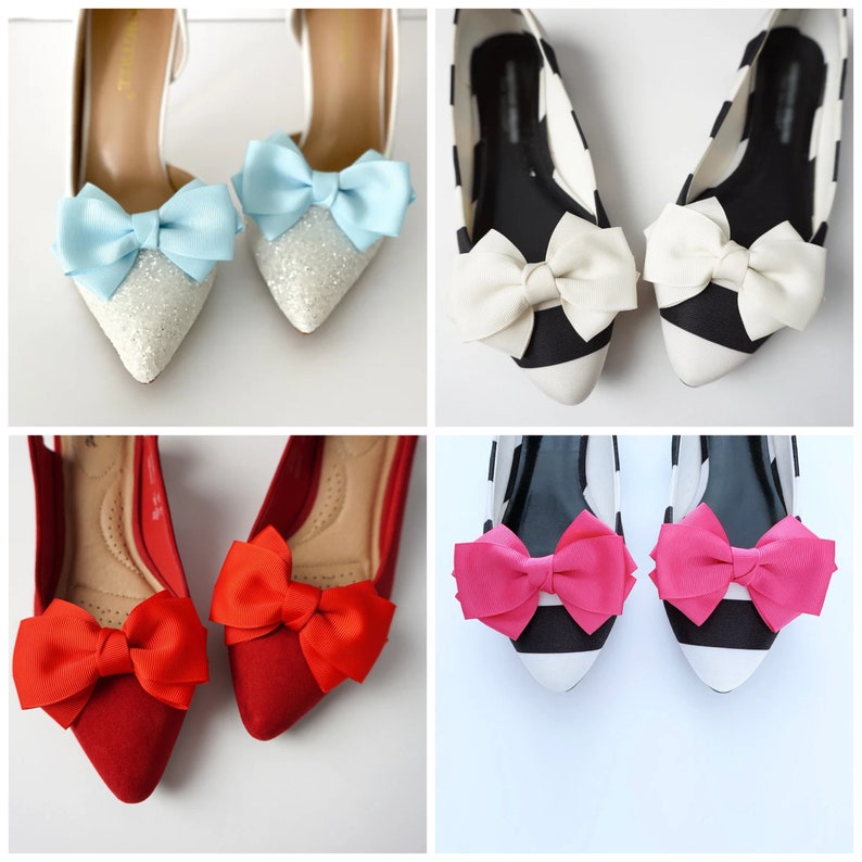 May include: Six pairs of flats with different colored bows. The bows are red, pink, white, and blue. The flats are black and white striped, white with glitter, and red.
