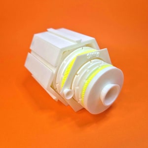 May include: White plastic 3D printed object with a yellow and white striped band and the word "Swing" printed on the side.