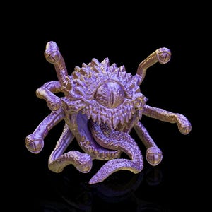 May include: A purple and gold fantasy creature with a large central eye, multiple tentacles, and a toothy mouth. The creature has a spiky, textured body and is set against a black background.