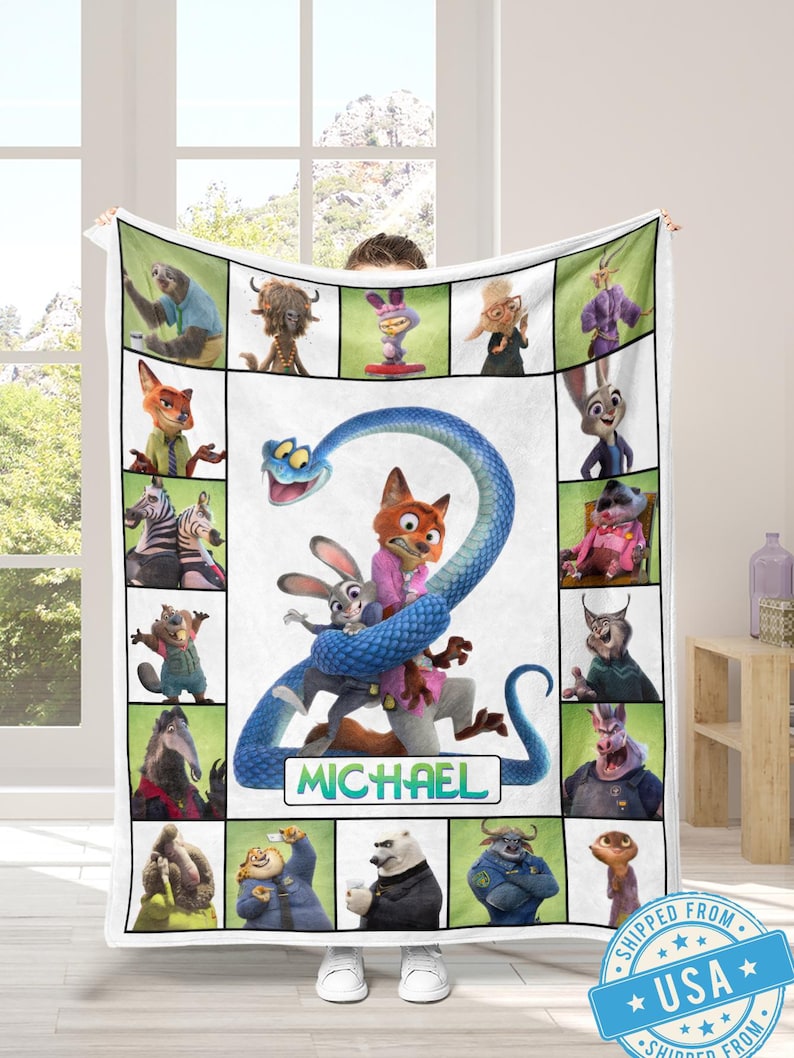 May include: A white blanket featuring characters from the animated movie Zootopia. The blanket has a central image of Nick Wilde, Judy Hopps, and a blue snake. The name "MICHAEL" is below the characters. Surrounding the central image are character portraits.