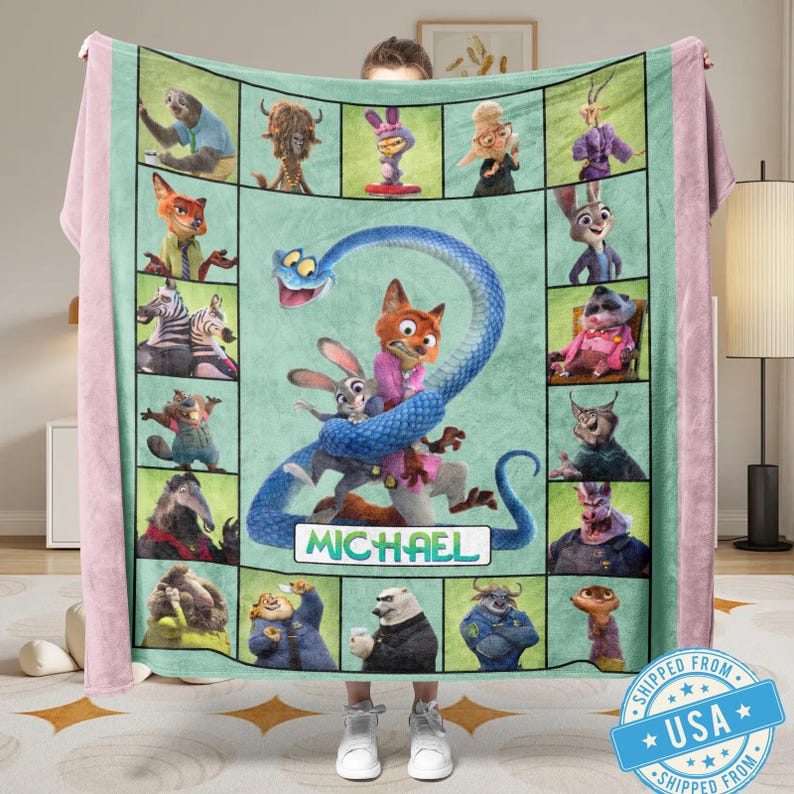 May include: A personalized fleece blanket featuring characters from the animated movie Zootopia. The blanket has a light green center with character portraits and a large blue snake design. The name "MICHAEL" is displayed on the blanket.