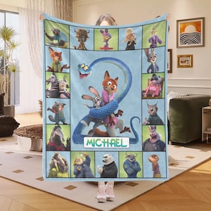 May include: A light blue fleece blanket featuring characters from the animated movie Zootopia. The blanket has a central image of Nick Wilde and Judy Hopps, with the name "MICHAEL" below. Surrounding the central image are various character portraits.