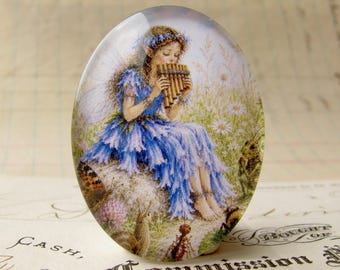 NEW! Meadow fairy playing a pan flute, 40x30mm glass oval cabochon, whimsical image exclusive to Fallen Angel Brass, handmade in this shop
