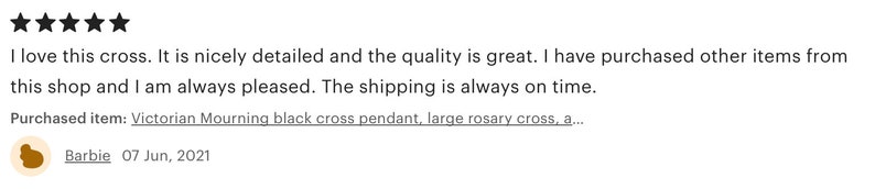 May include: A customer review with five stars, praising a Victorian Mourning black cross pendant. The review mentions the quality and detail of the cross, and the customer's satisfaction with the shop.