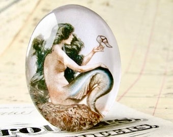 From 1921, mermaid holding a shoe, wishing for legs, vintage magazine cover, handmade glass oval cabochon, 40x30 or 25x18, magical