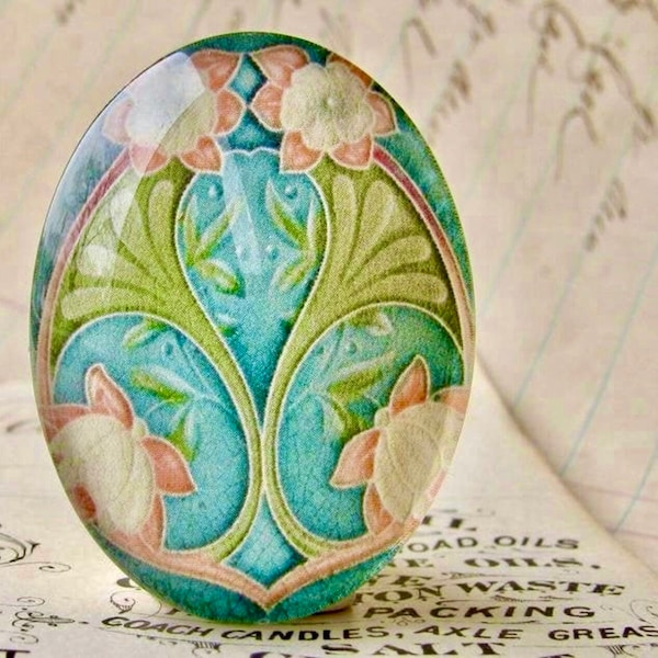 Art Nouveau ceramic tile image under glass dome, handmade 40x30mm oval cabochon, Belle Époque, blue orange flower, green stem