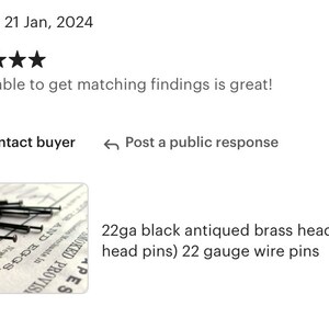 May include: A close-up of a pile of 22 gauge black antiqued brass headpins. The headpins are arranged on a piece of paper with text that reads "SMOKED PROVISIONED PACKAGES 10", "Newburgh, N.Y.", and "PES".