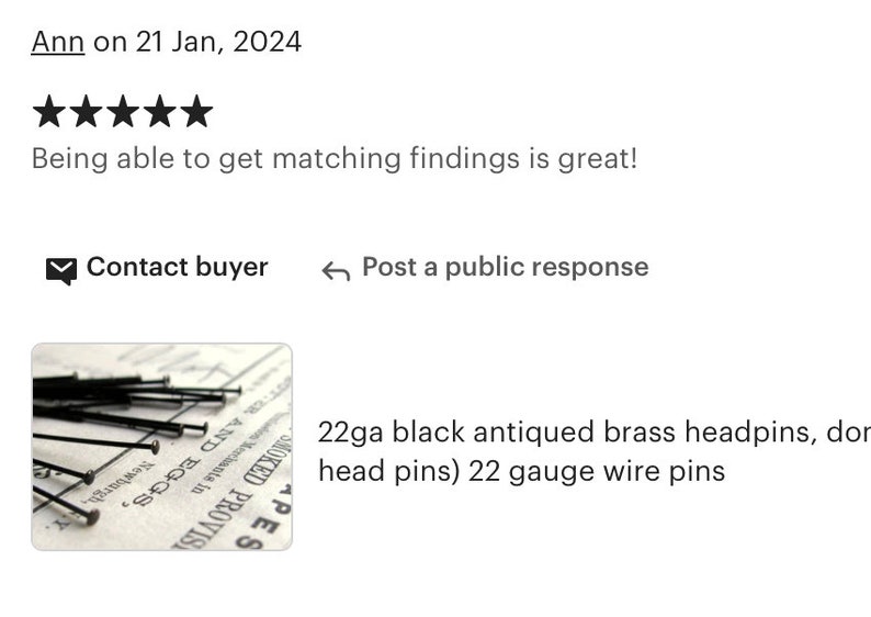 May include: A close-up of a pile of 22 gauge black antiqued brass headpins. The headpins are arranged on a piece of paper with text that reads "SMOKED PROVISIONED PACKAGES 10", "Newburgh, N.Y.", and "PES".
