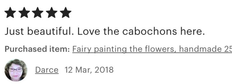 May include: Five star review for a handmade fairy painting the flowers. The review says "Just beautiful. Love the cabochons here." and is dated March 12, 2018.