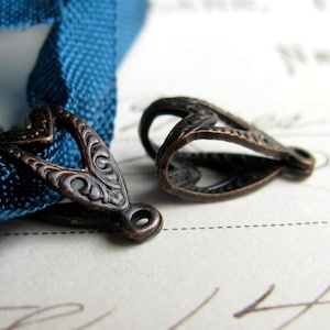 May include: A set of three ceramic nesting bowls in graduating sizes. The bowls are white with a blue floral pattern and a scalloped edge. The largest bowl is approximately 8 inches in diameter.