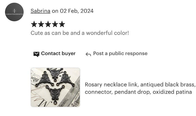 May include: Three black metal pendant drops with ornate designs. The pendants are connected by small rings. The pendants are on a white background with black text.